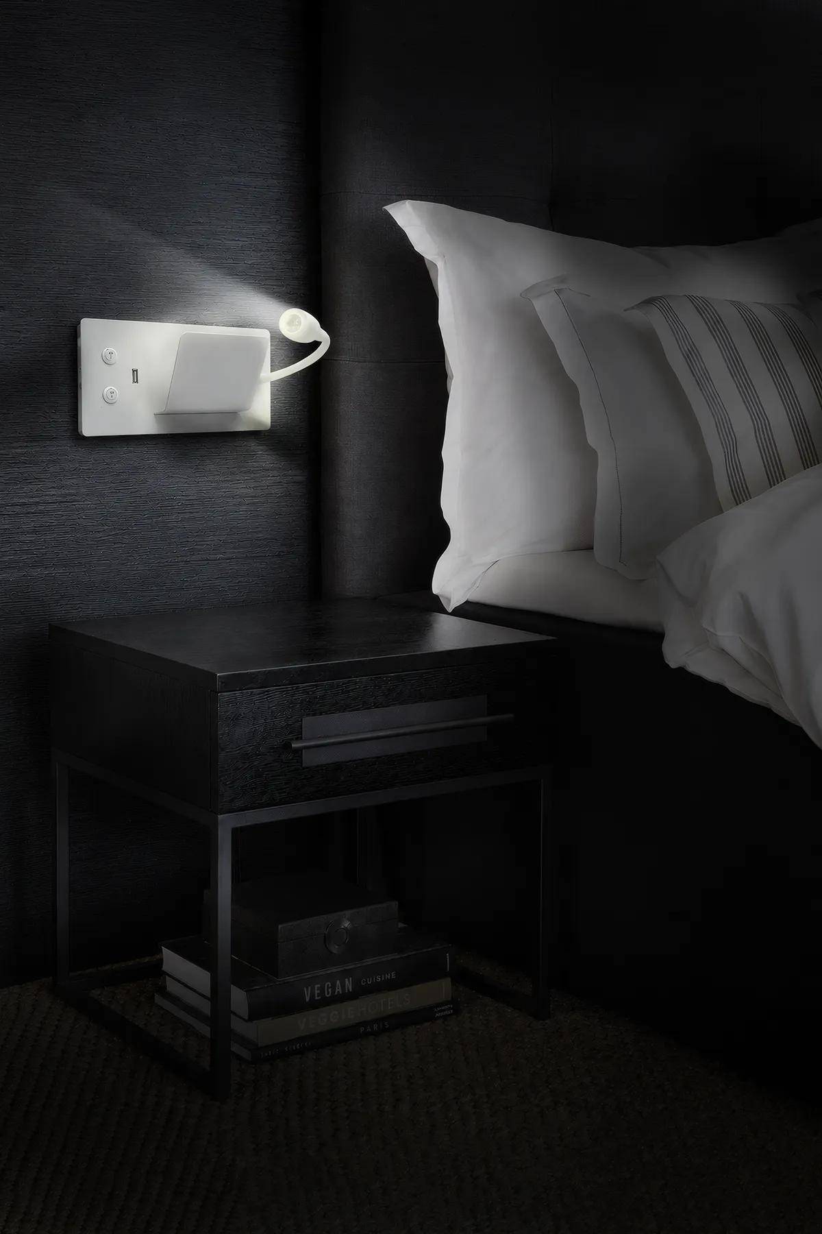 Bedside reading light in a softly lit bedroom